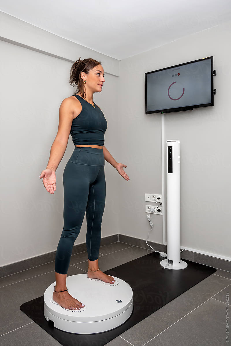 A woman on a 3D body scanner
